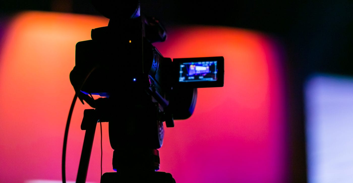 Silhouette of a TV Camera filming a live broadcast